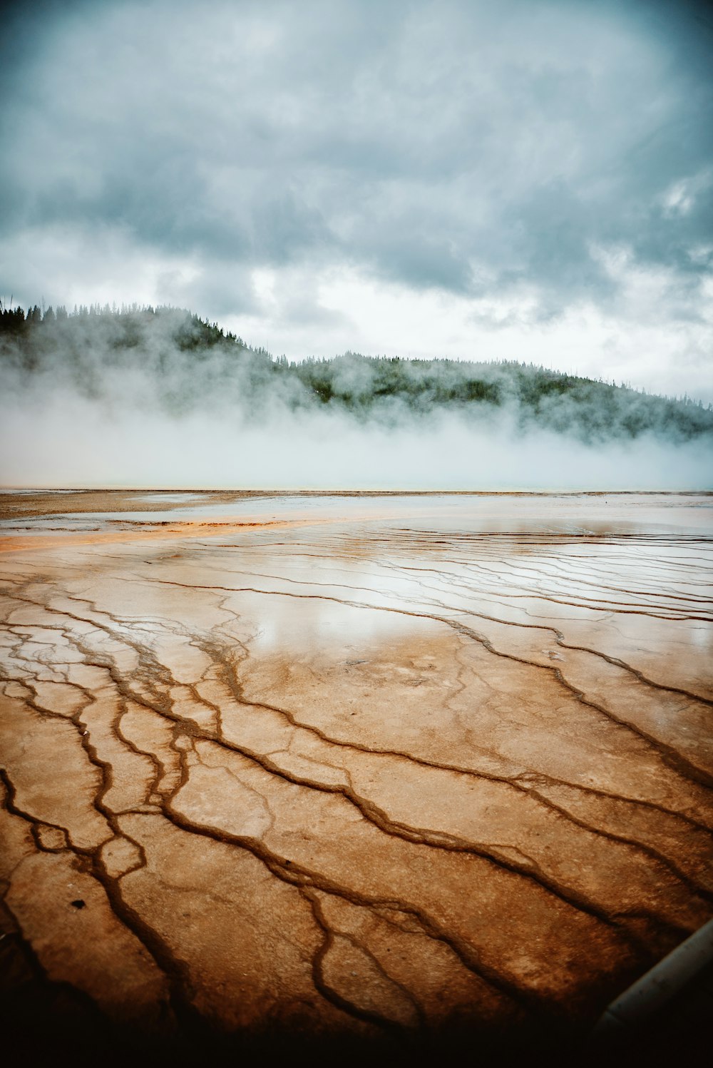 a large body of water with steam coming out of it