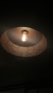 A beautifully designed ceiling lamp hanging in a bright space.