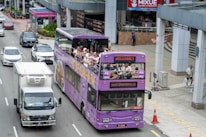 Happy travelers enjoying a city sightseeing tour from a comfortable bus window.