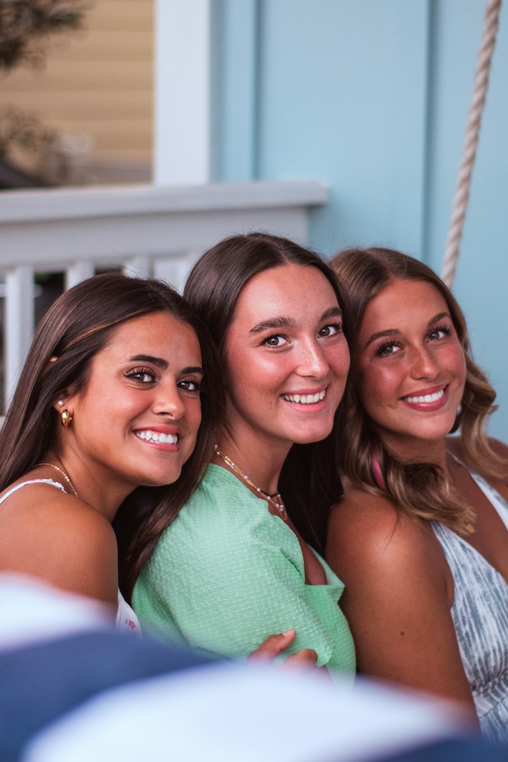 three beautiful young women sitting next to each other