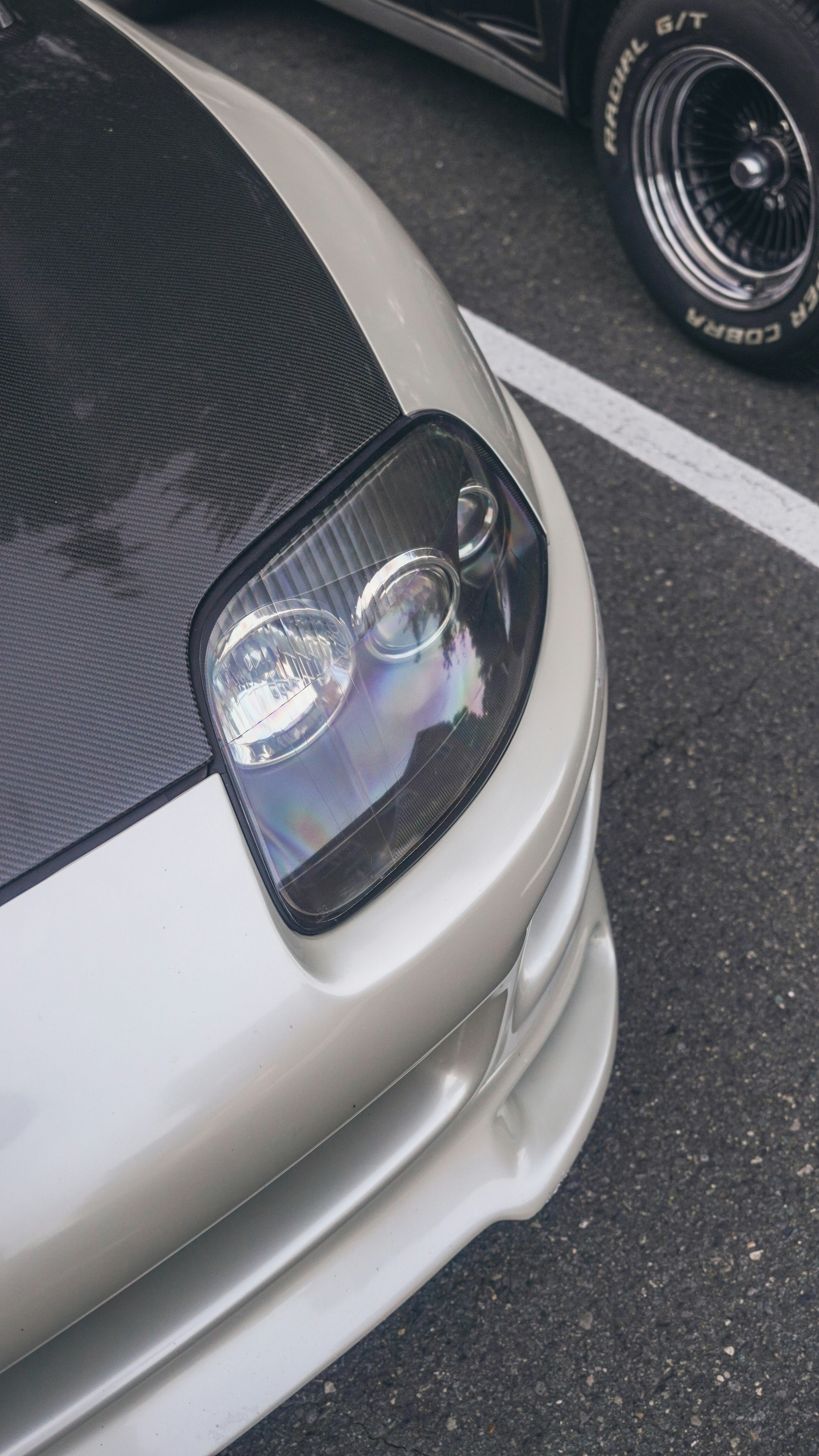 a close up of the front of a white sports car