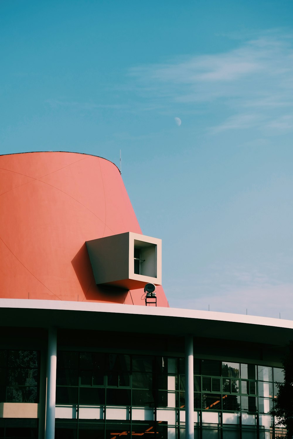 a red building with a clock on the top of it