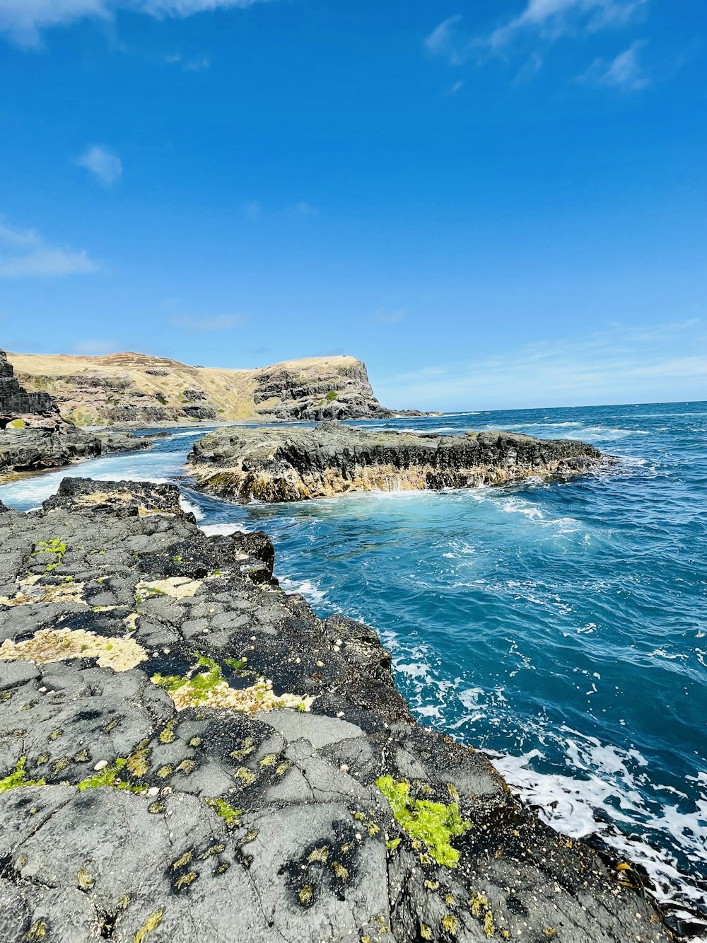 a view of the ocean from a rocky cliff