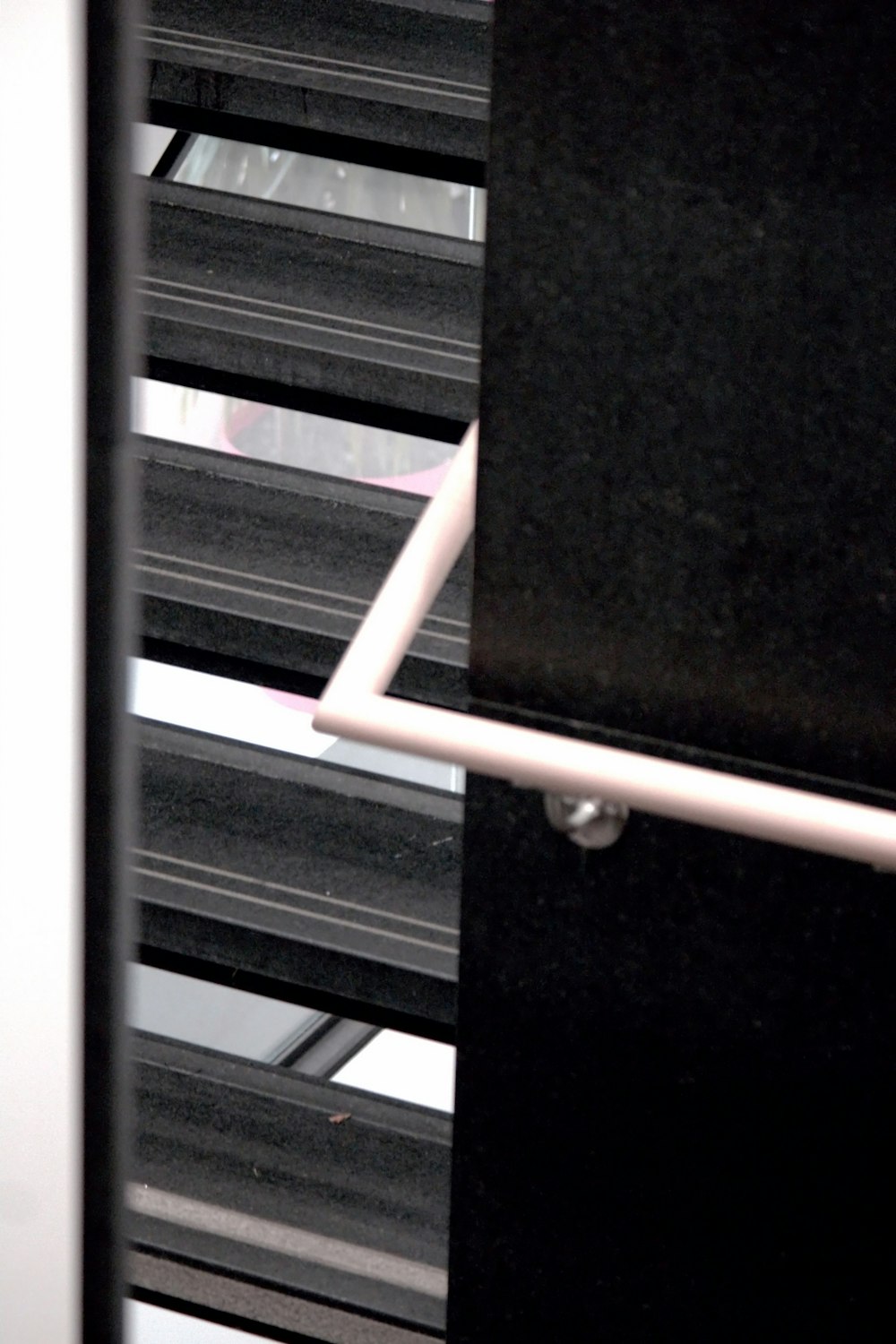 a black and white photo of a window with blinds