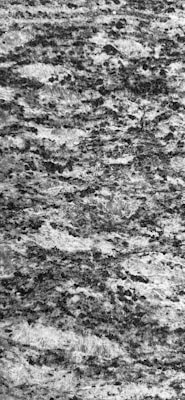 A textured surface featuring a complex pattern of black and white speckles and swirls, resembling natural granite stone. The intricate design includes various shades of gray, creating a rich and detailed appearance.