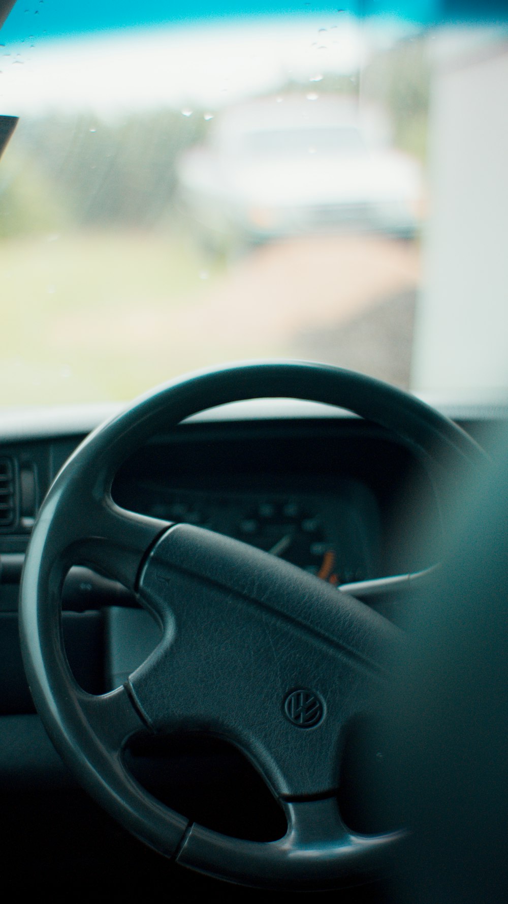 a car dashboard with a steering wheel and dashboard lights