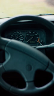 A close-up of a car's dashboard with a focus on the speedometer and fuel gauge, symbolizing car appraisal.