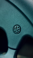 A close-up of a steering wheel wrapped in genuine leather.