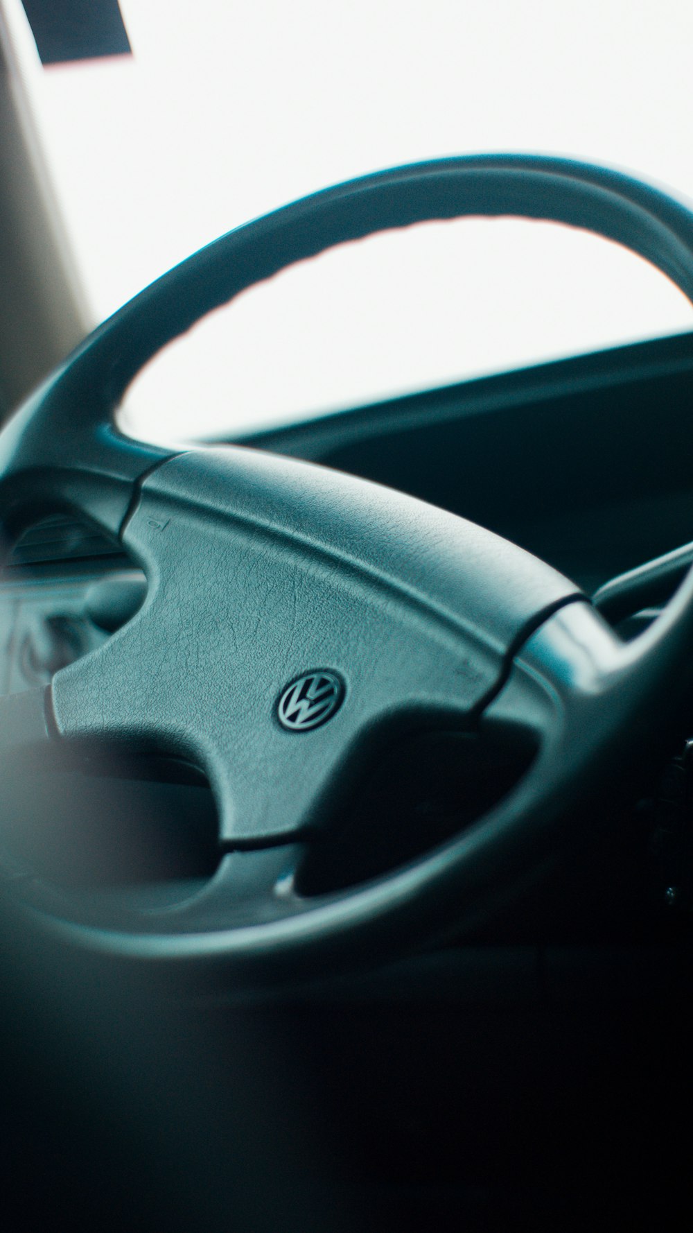 a steering wheel of a car with a dashboard