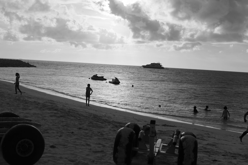 a group of people standing on top of a sandy beach