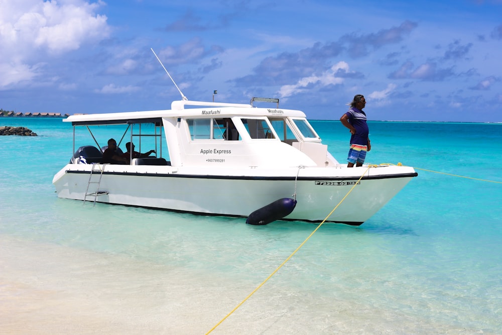 a man standing on a boat in the water