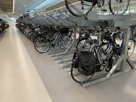 A well-organized bike parking area with multiple bicycles secured to racks.