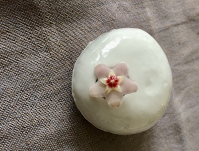 Elegant small decorative object with a smooth matte finish, placed on a clean white surface.