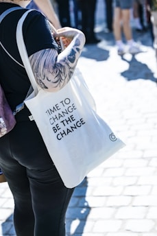 a woman carrying a bag with a message on it