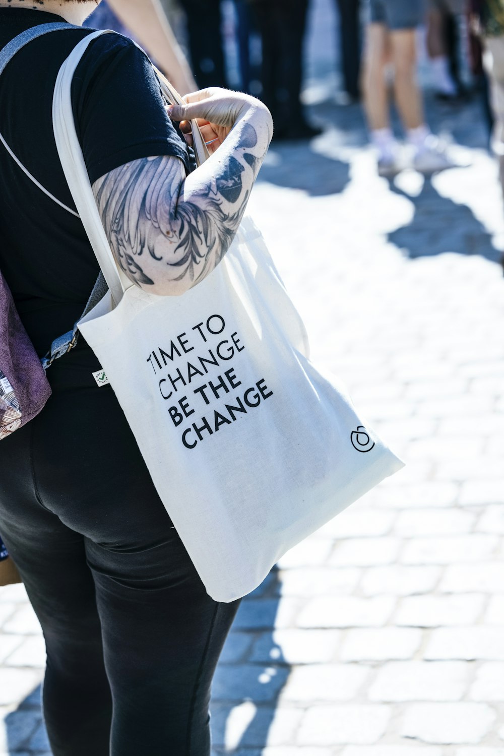 a woman carrying a bag with a message on it