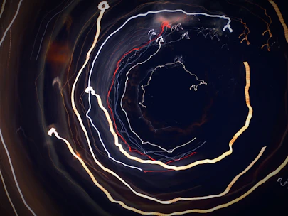 Close-up of a hypnotic spiral blending into cosmic light patterns.
