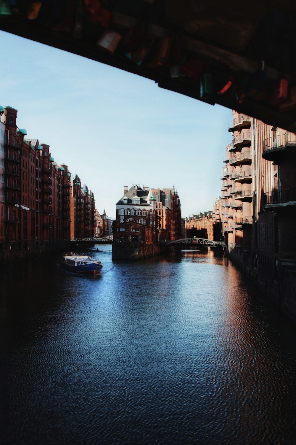 a boat traveling down a river next to tall buildings