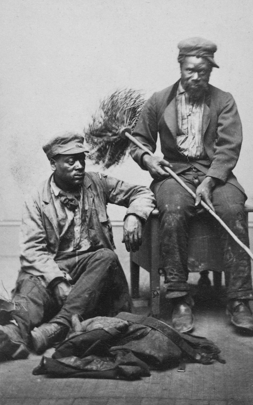 Occupational portrait of two African American chimney sweeps.