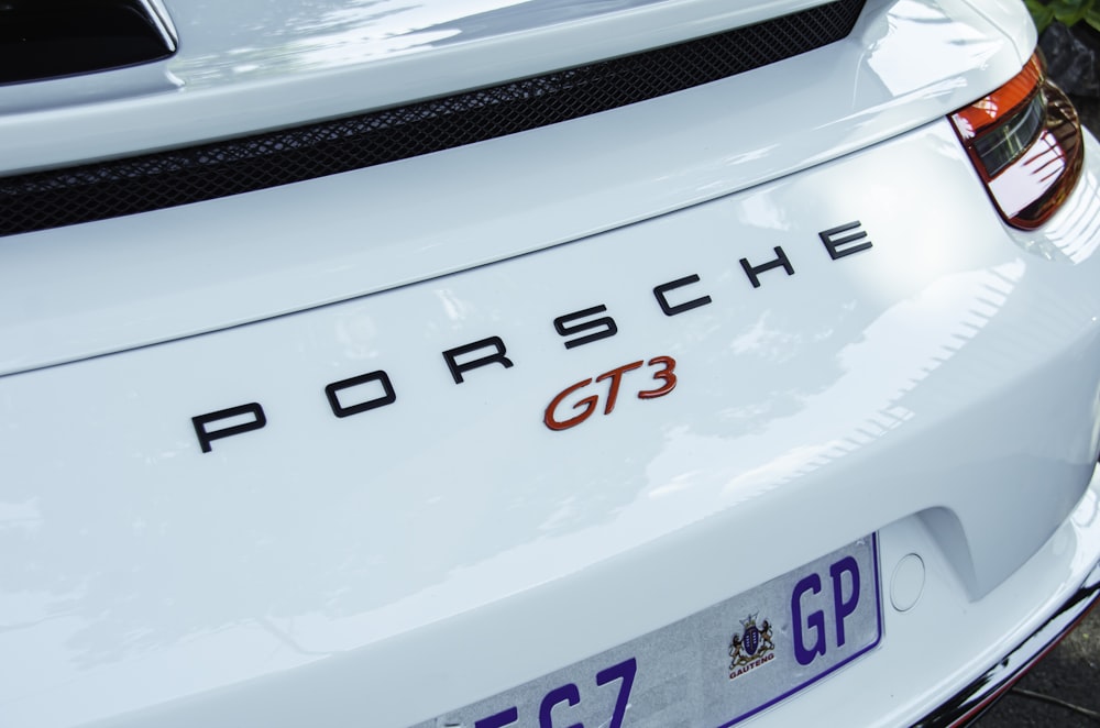 a white porsche gt3 parked on the side of a road