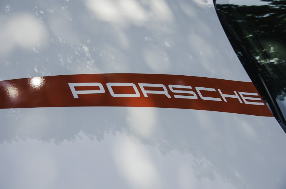 a close up of a porsche logo on the side of a car