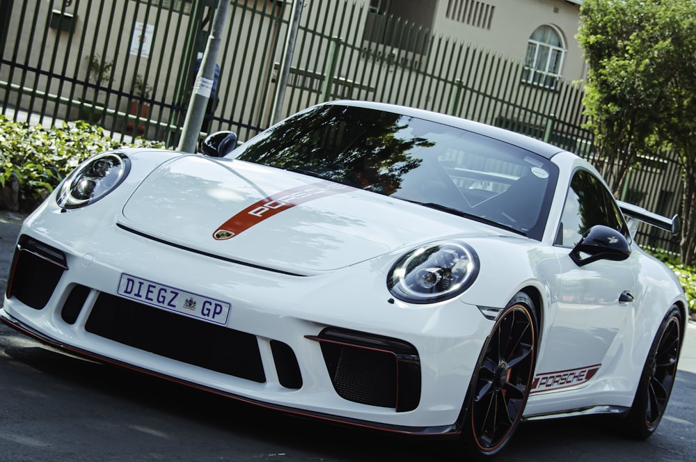 a white sports car parked on the side of the road