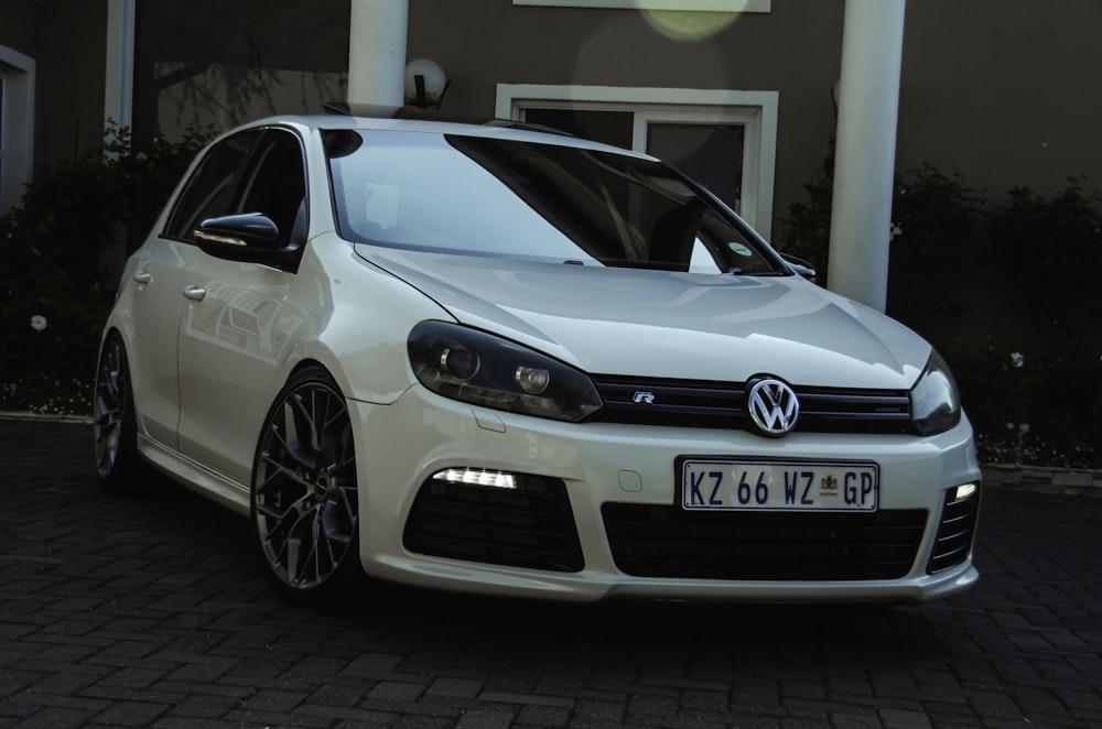 a white car parked in front of a building