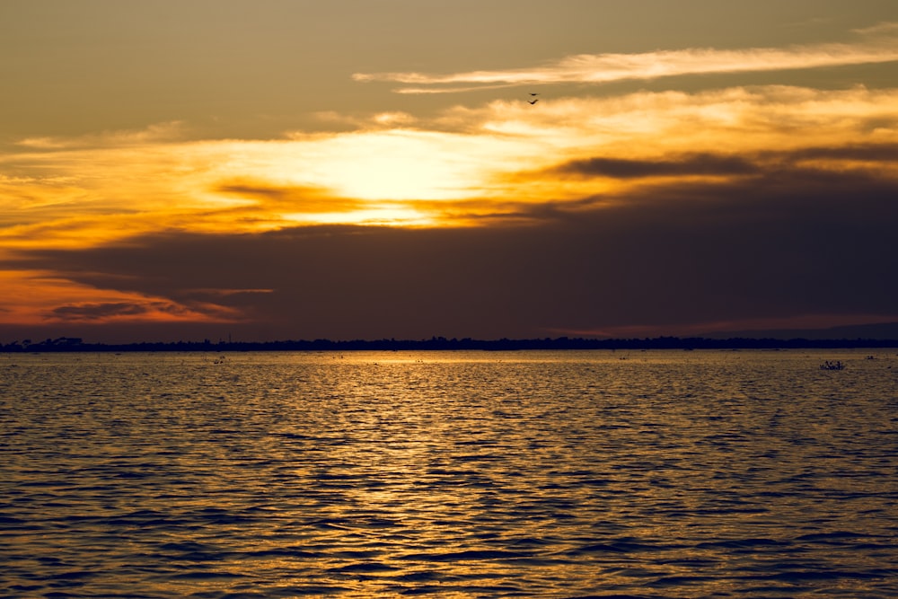 a large body of water under a cloudy sky