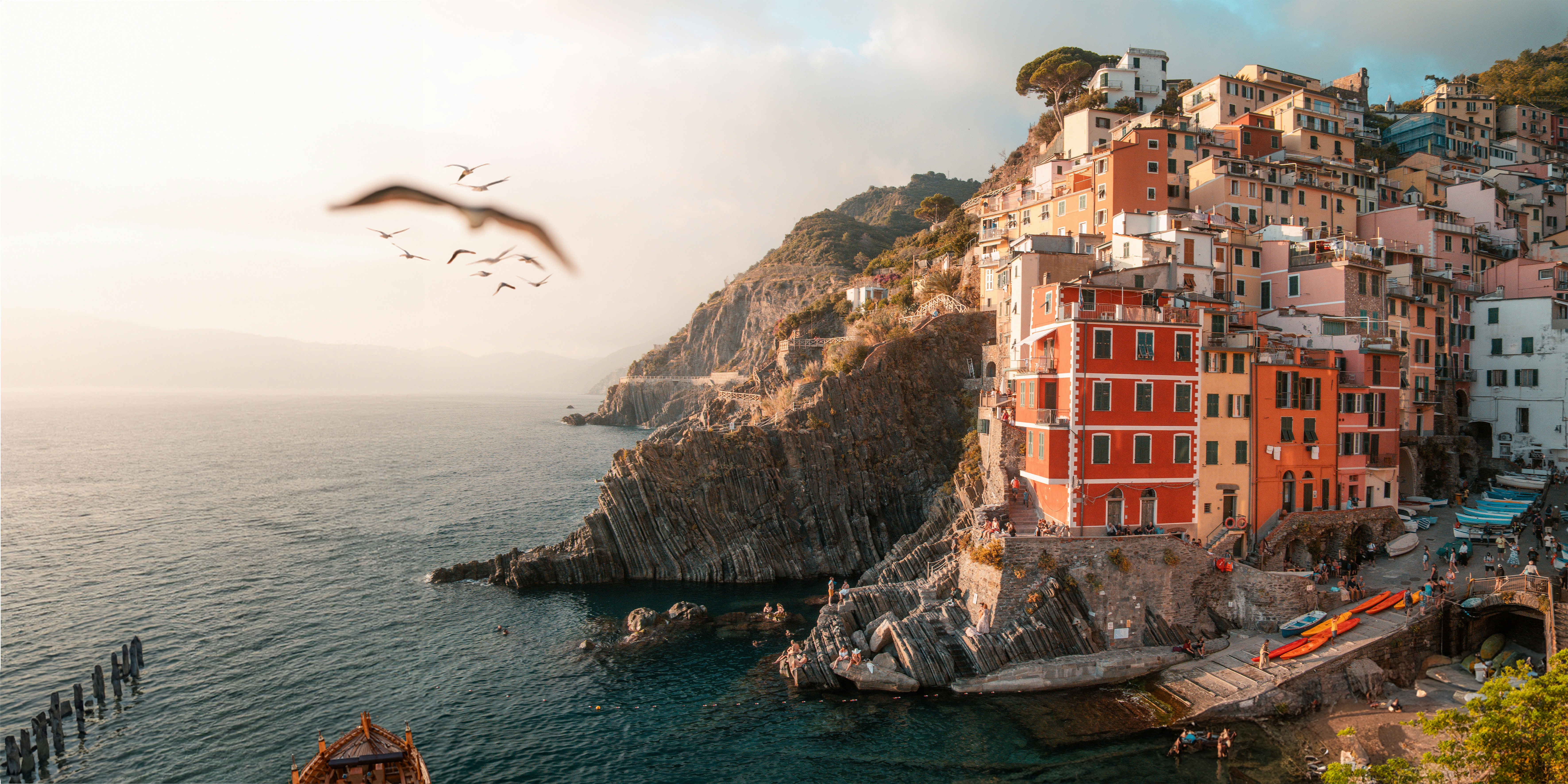 a bird flying over a body of water, I was in Italy with my Girlfriend and got some great Pictures from Cinque Terre.