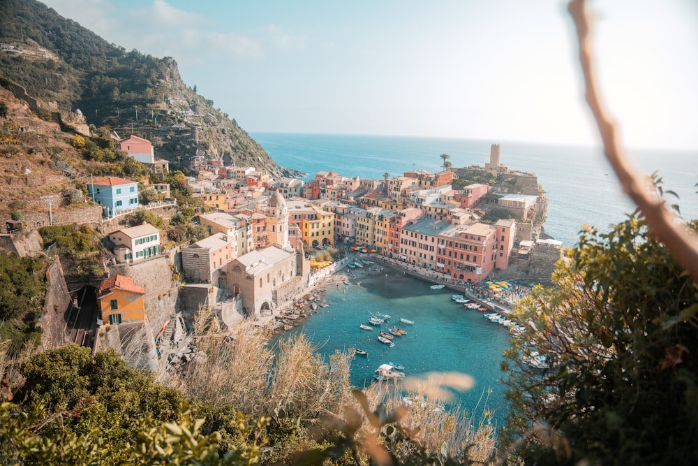 a view of a village on a cliff overlooking the ocean