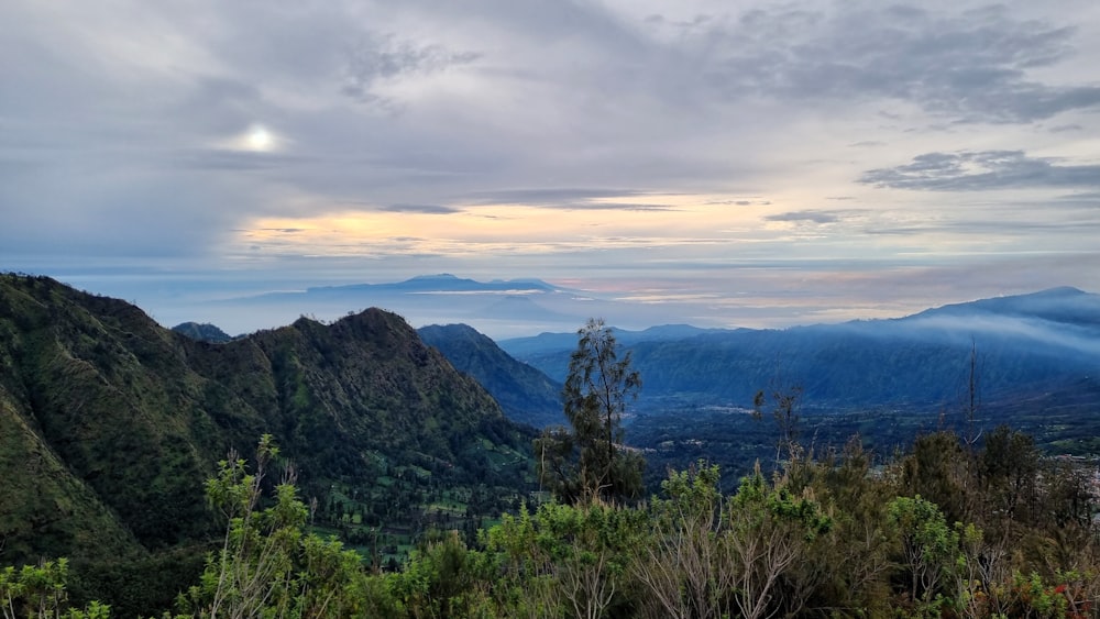 a view of a mountain range with clouds in the sky