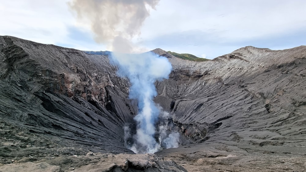 a view of a mountain with a plume of smoke coming out of it