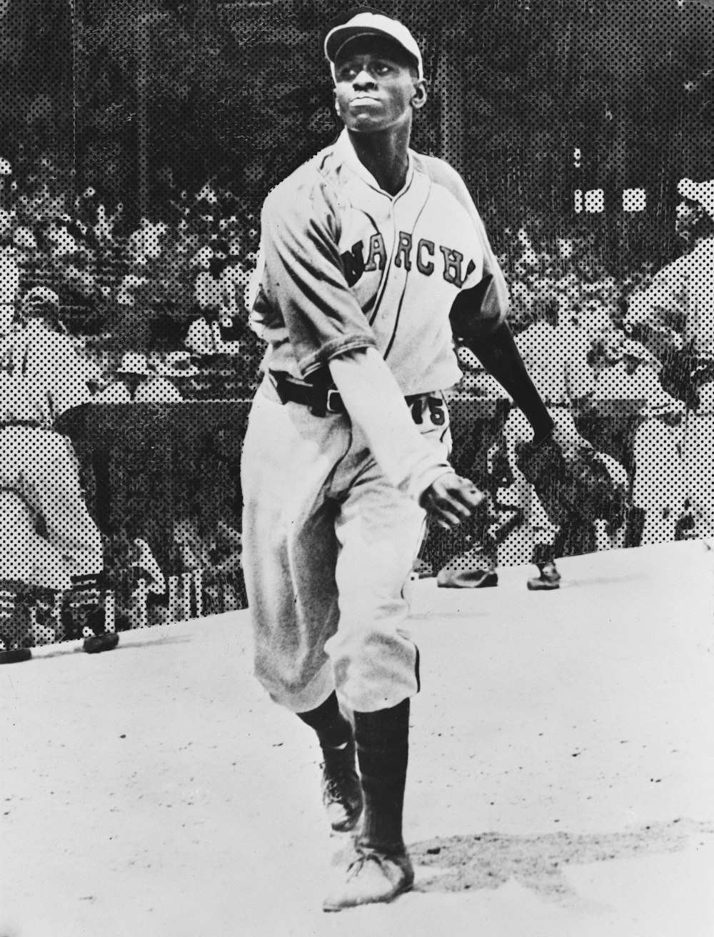Satchel Paige, in the Kansas City Monarchs uniform at a baseball game.