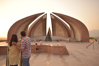 The iconic Monas monument glowing at sunset, with tour participants gathered nearby.