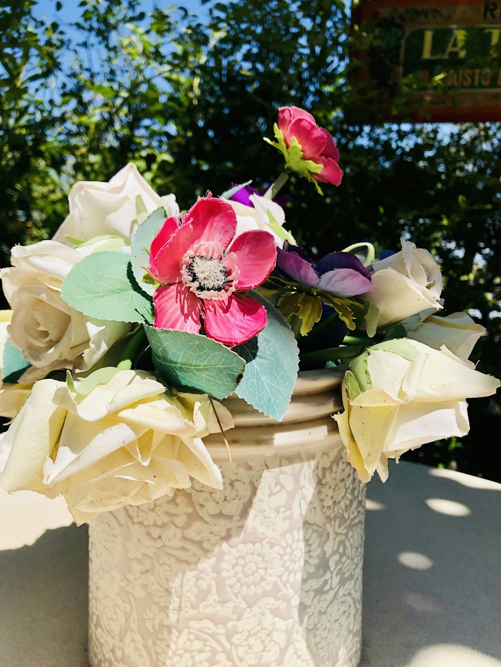 a close up of a vase with flowers in it