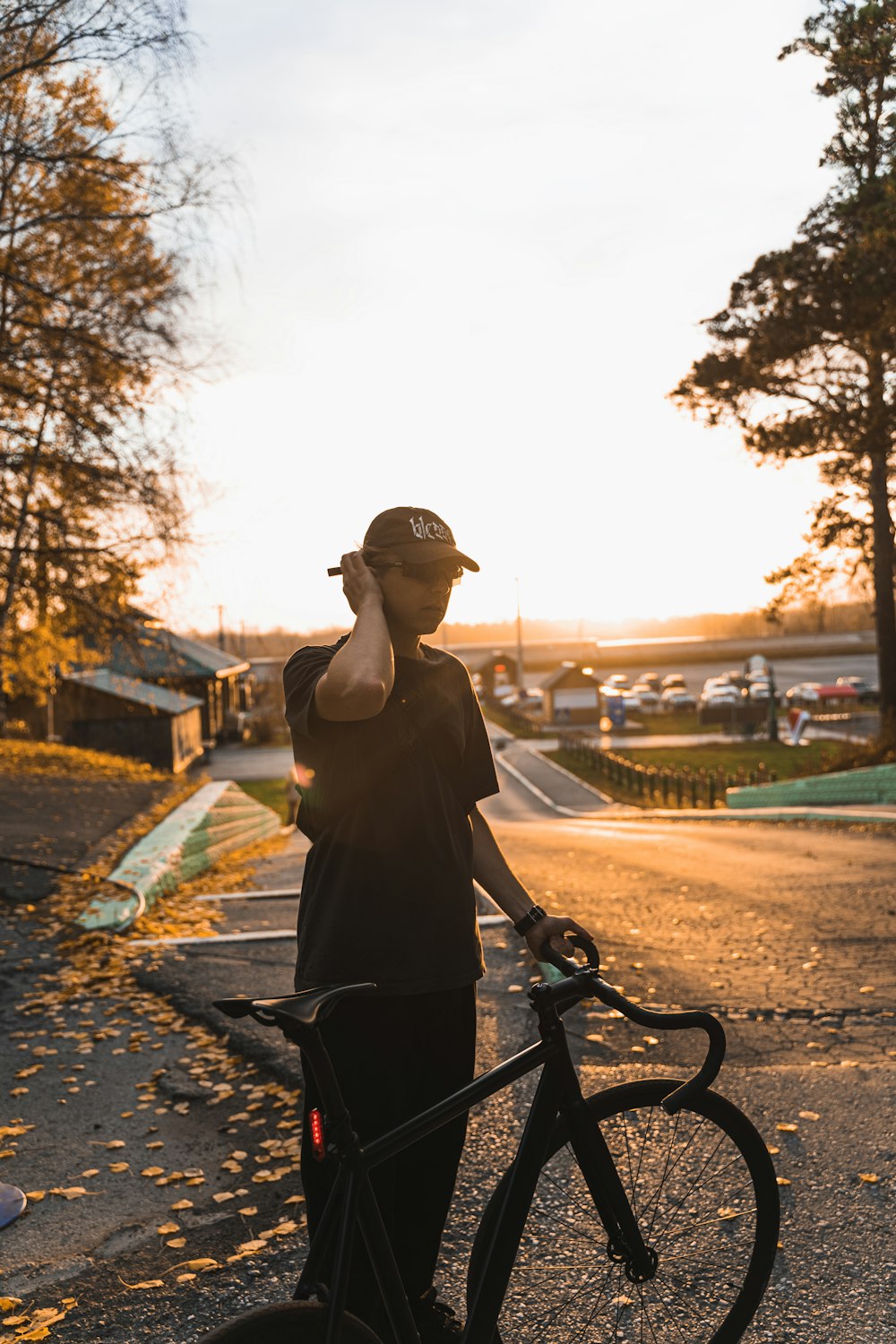 a man standing next to a bike talking on a cell phone