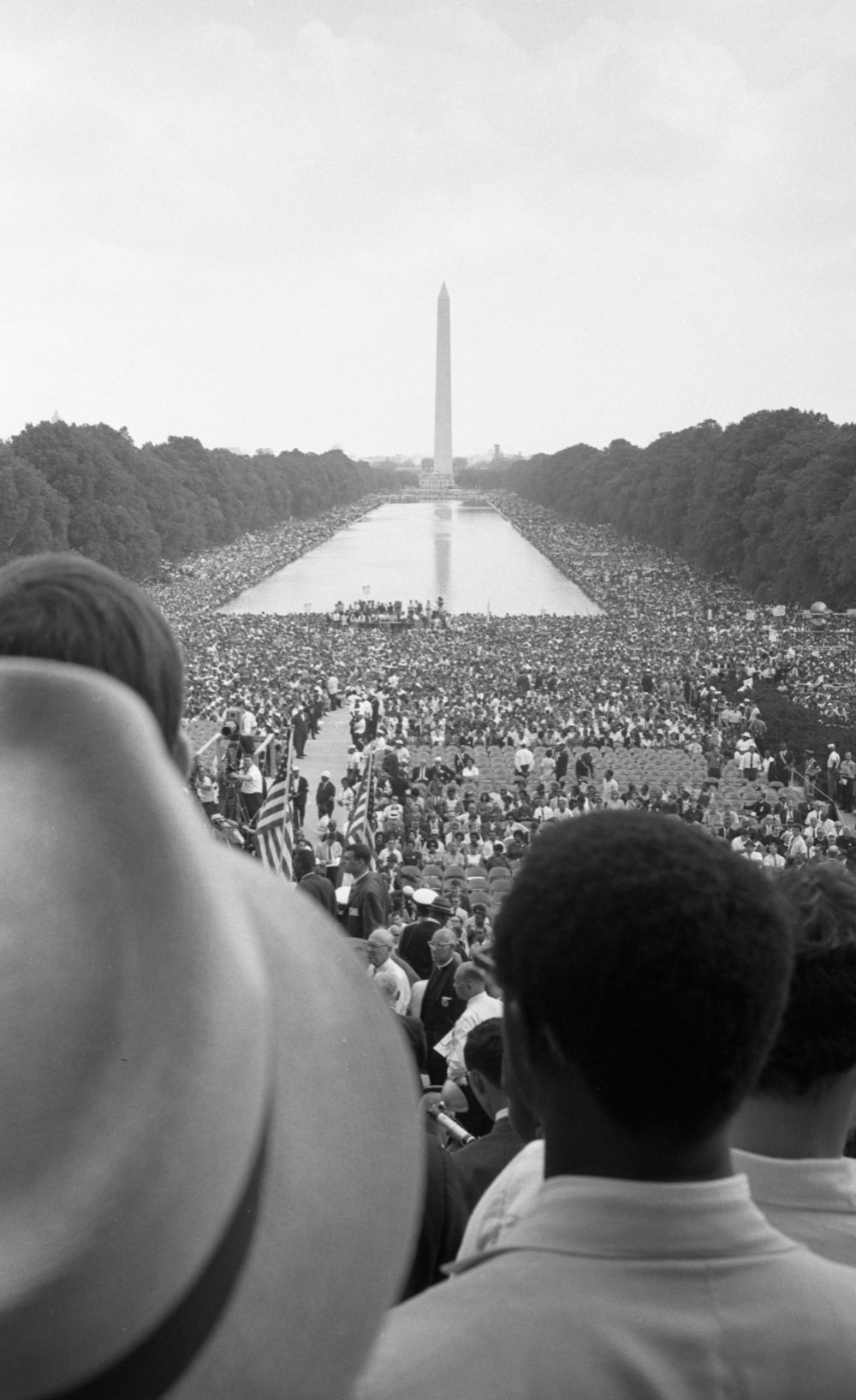 A crowd of African Americans and whites surrounding the Reflecting Pool and continuing to the Washington Monument.