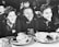 A group of diverse children enjoying a healthy meal together in a bright, cheerful cafeteria.