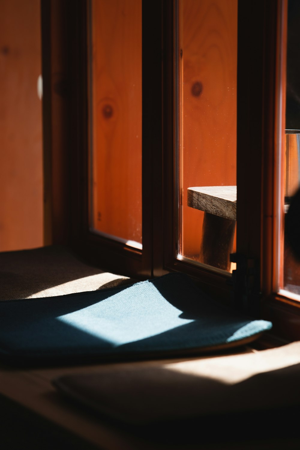 a room with a window and a blue mat on the floor