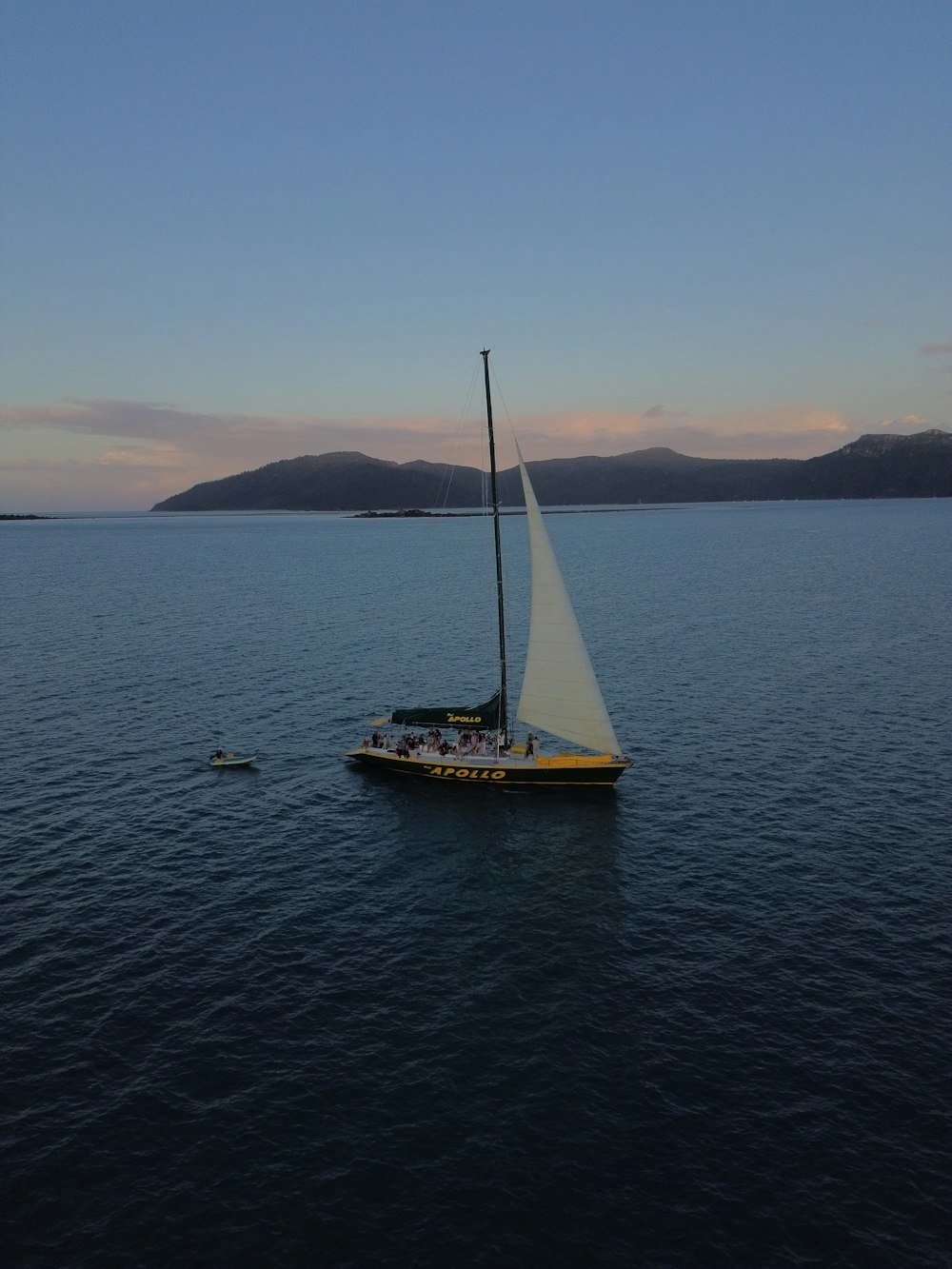 a sailboat in the middle of a body of water