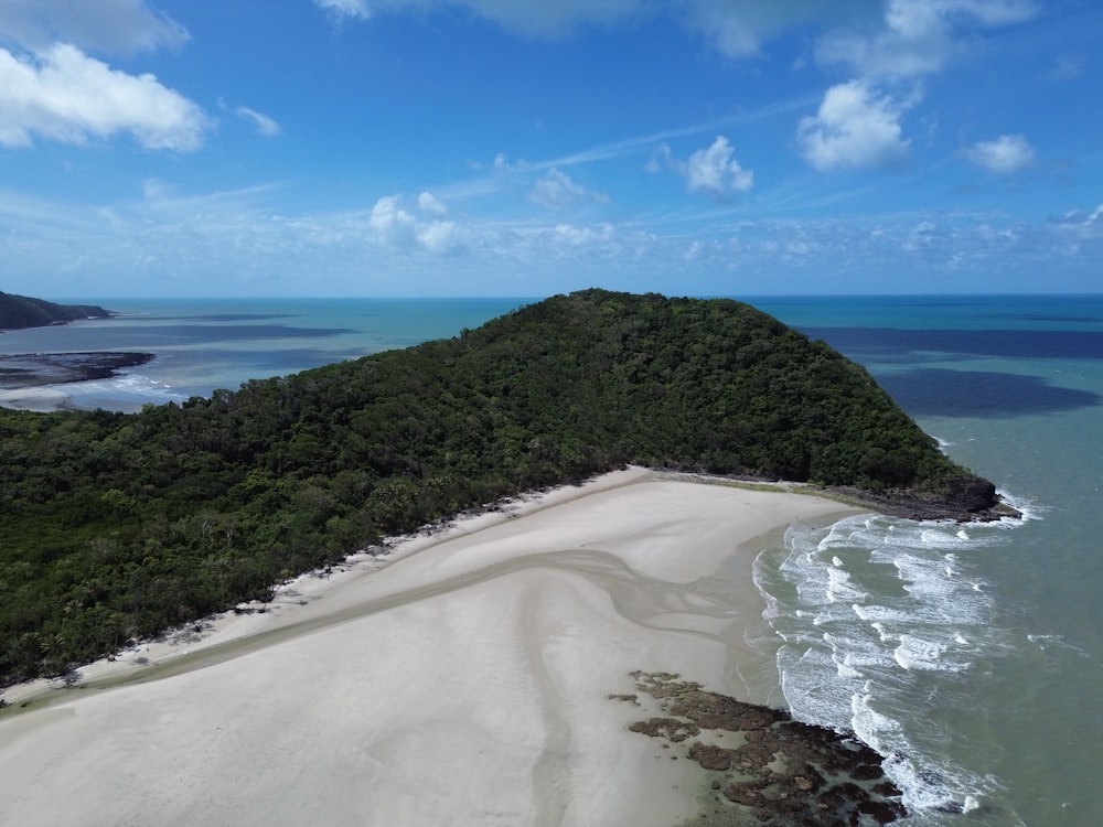 an aerial view of a sandy beach and ocean