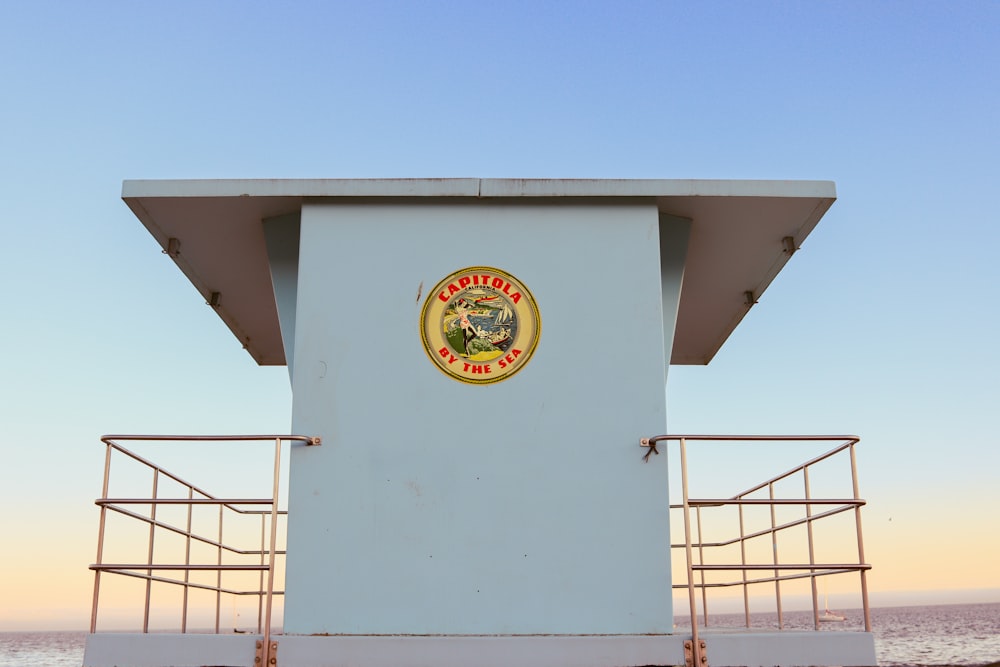 a lifeguard tower on a beach with the ocean in the background