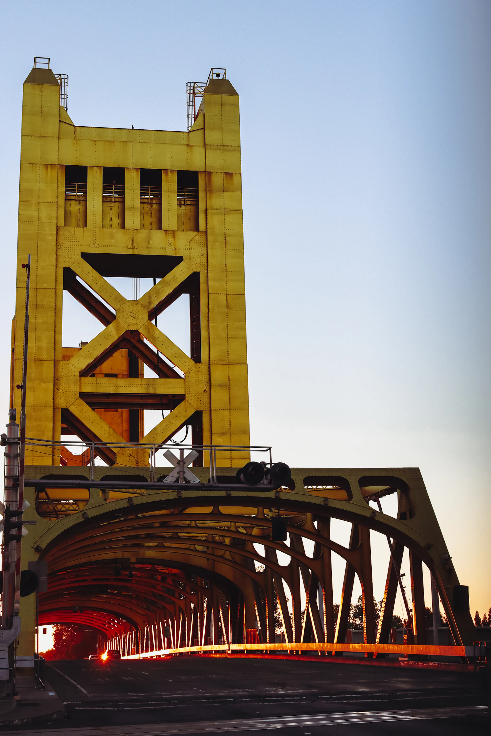 A yellow lift bridge over a river.