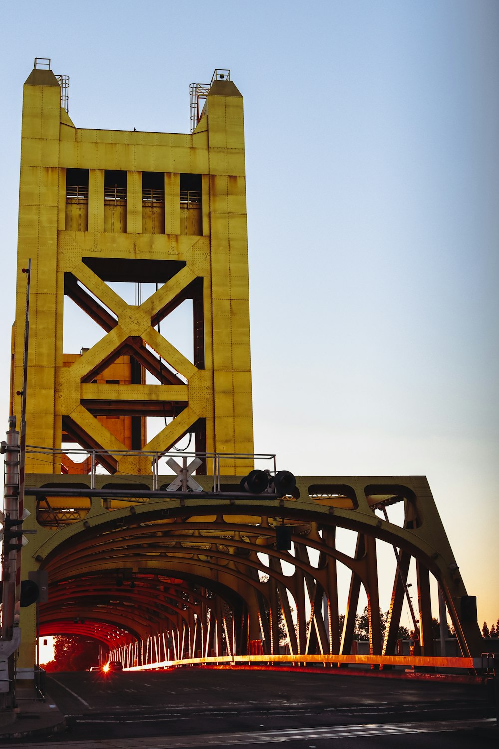 a yellow bridge with a train going over it