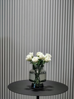 A close-up of elegant roses arranged in a minimalist setting.