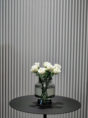 A close-up of elegant roses arranged in a minimalist setting.
