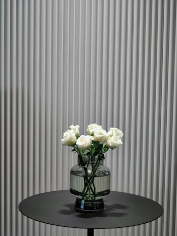 A minimalist arrangement of infinity roses displayed in a sleek, modern vase.