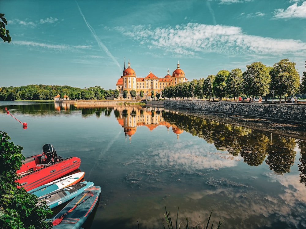 a body of water surrounded by trees and a large building