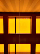 Sunlit interior of a stylish apartment with warm yellow tones.