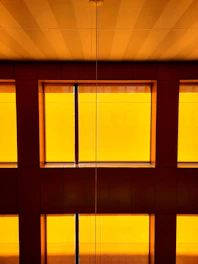 Cozy and elegant interior of a physical training center with mustard yellow and dark purple accents, showing warm natural light and welcoming atmosphere.