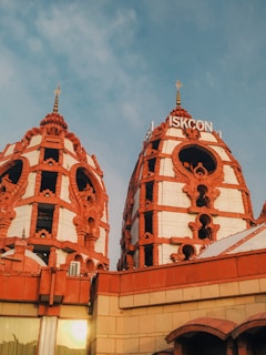 a building with two towers and a sky background